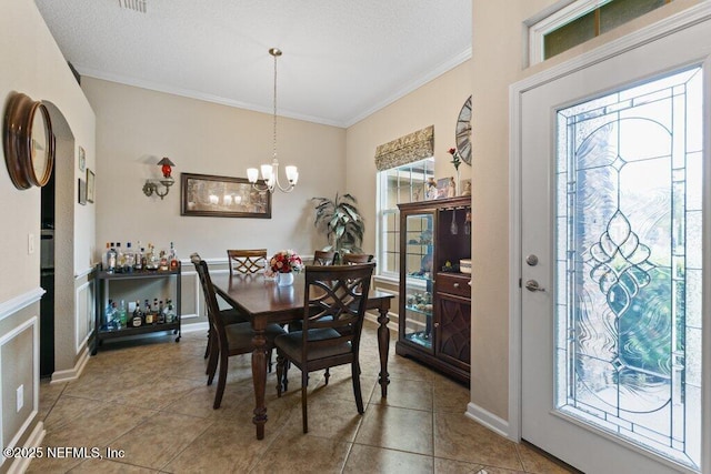 3912 Pipit Pt, Middleburg, FL 32068 - dining area with crown molding, a chandelier, a textured ceiling, tile patterned floors, and baseboards