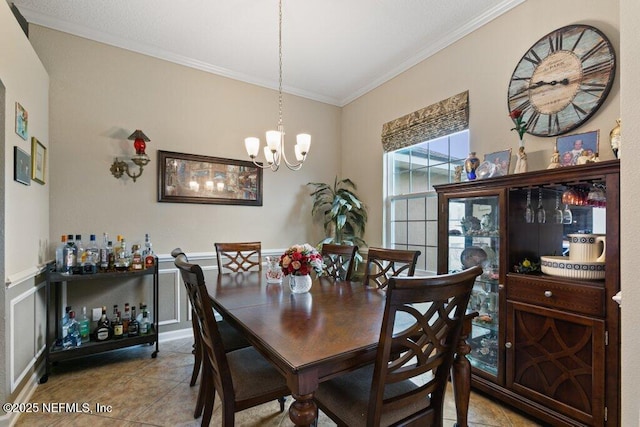 3912 Pipit Pt, Middleburg, FL 32068 - tiled dining area with crown molding, a chandelier, and wainscoting
