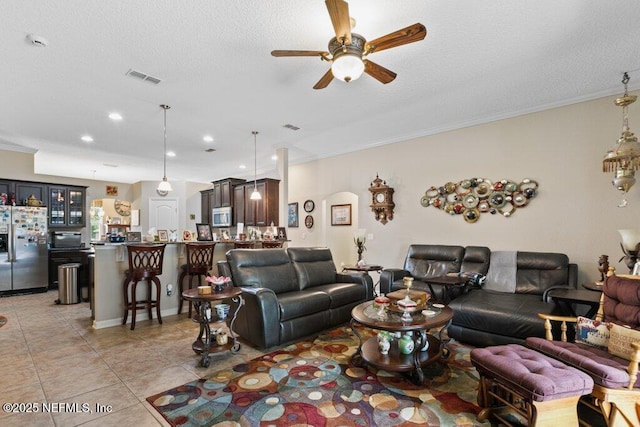 3912 Pipit Pt, Middleburg, FL 32068 - living room with ceiling fan, crown molding, light tile patterned floors, a textured ceiling, and recessed lighting