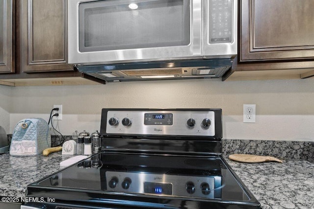 3912 Pipit Pt, Middleburg, FL 32068 - kitchen view of appliances with stainless steel finishes, dark brown cabinets, and stone countertops