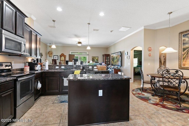 3912 Pipit Pt, Middleburg, FL 32068 - kitchen featuring appliances with stainless steel finishes, light tile patterned floors, arched walkways, crown molding, and dark stone countertops
