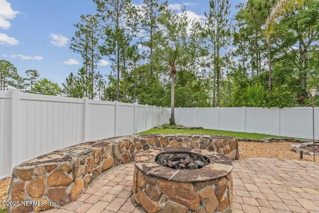 3912 Pipit Pt, Middleburg, FL 32068 - fenced backyard featuring a fire pit and a patio