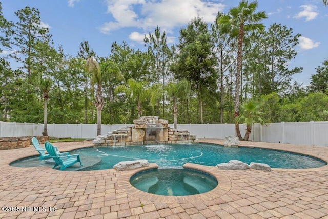 3912 Pipit Pt, Middleburg, FL 32068 - view of swimming pool featuring a patio area, a fenced backyard, a pool with connected hot tub, and view of wooded area