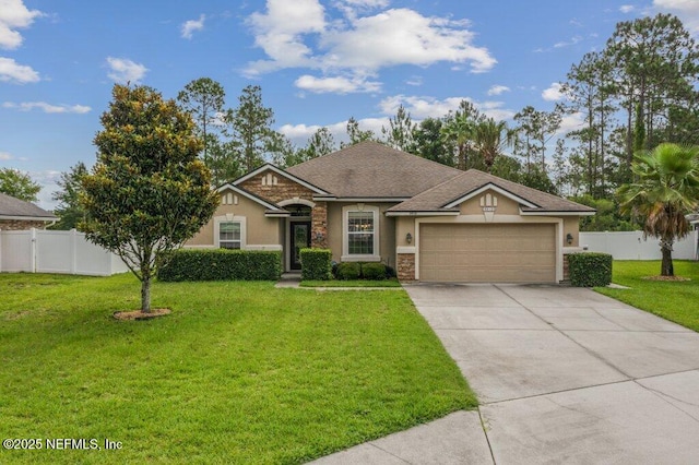 3912 Pipit Pt, Middleburg, FL 32068 - view of front facade with stucco siding, stone siding, an attached garage, and driveway