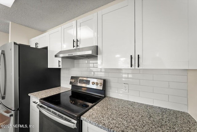 1528 Jordan St, Atlantic Beach, FL 32233 - kitchen featuring under cabinet range hood, appliances with stainless steel finishes, white cabinets, light stone counters, and tasteful backsplash
