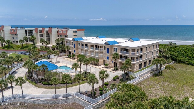 7790 A1A Unit 103, Saint Augustine, FL 32080 - drone / aerial view of a pool area, a nearby body of water, and apartment complex / building