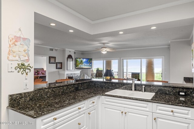 7790 A1A Unit 103, Saint Augustine, FL 32080 - kitchen with a sink, recessed lighting, crown molding, white cabinetry, and open floor plan