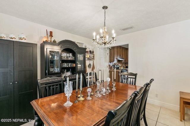 2041 Mill Creek Rd, Jacksonville, FL 32211 - dining room with a chandelier, light tile patterned floors, baseboards, and a textured ceiling