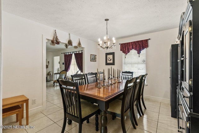 2041 Mill Creek Rd, Jacksonville, FL 32211 - dining space with light tile patterned floors, healthy amount of natural light, a chandelier, a textured ceiling, and baseboards