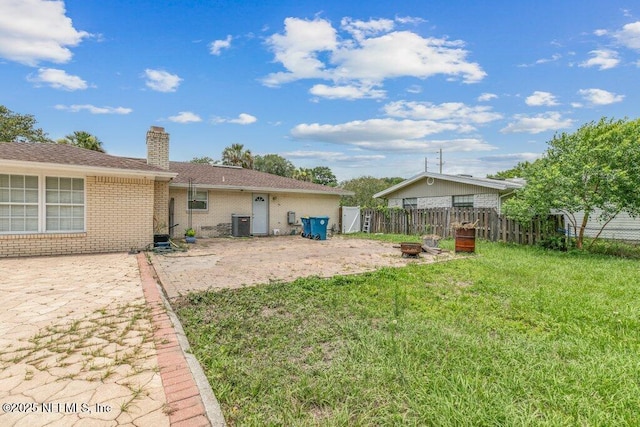 2041 Mill Creek Rd, Jacksonville, FL 32211 - back of house with a fire pit, brick siding, a chimney, and a patio area