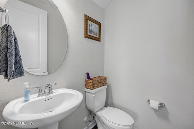 4604 Clapboard Crossing Way, Jacksonville, FL 32226 - bathroom with a sink, toilet, and baseboards