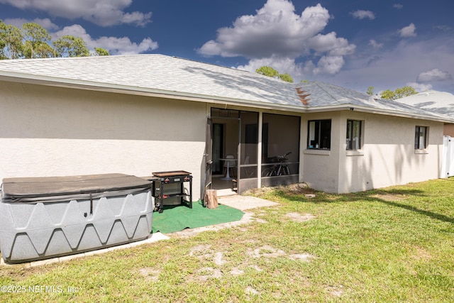 14 Ballard Ln, Palm Coast, FL 32137 - back of house with stucco siding, a sunroom, a lawn, and roof with shingles