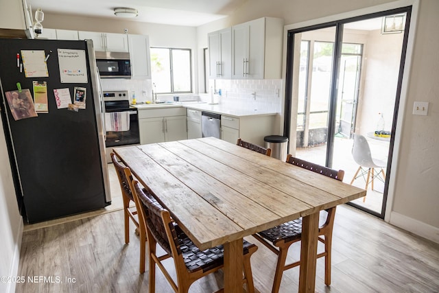 14 Ballard Ln, Palm Coast, FL 32137 - kitchen featuring appliances with stainless steel finishes, tasteful backsplash, light wood-style floors, light countertops, and white cabinets