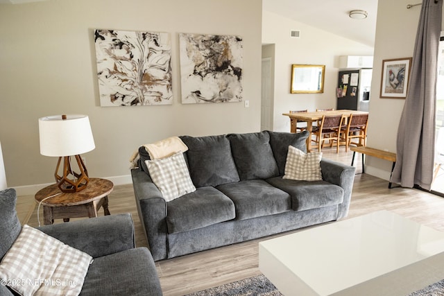 14 Ballard Ln, Palm Coast, FL 32137 - living area featuring light wood-style flooring and vaulted ceiling
