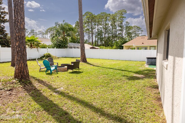 14 Ballard Ln, Palm Coast, FL 32137 - fenced backyard with a fire pit
