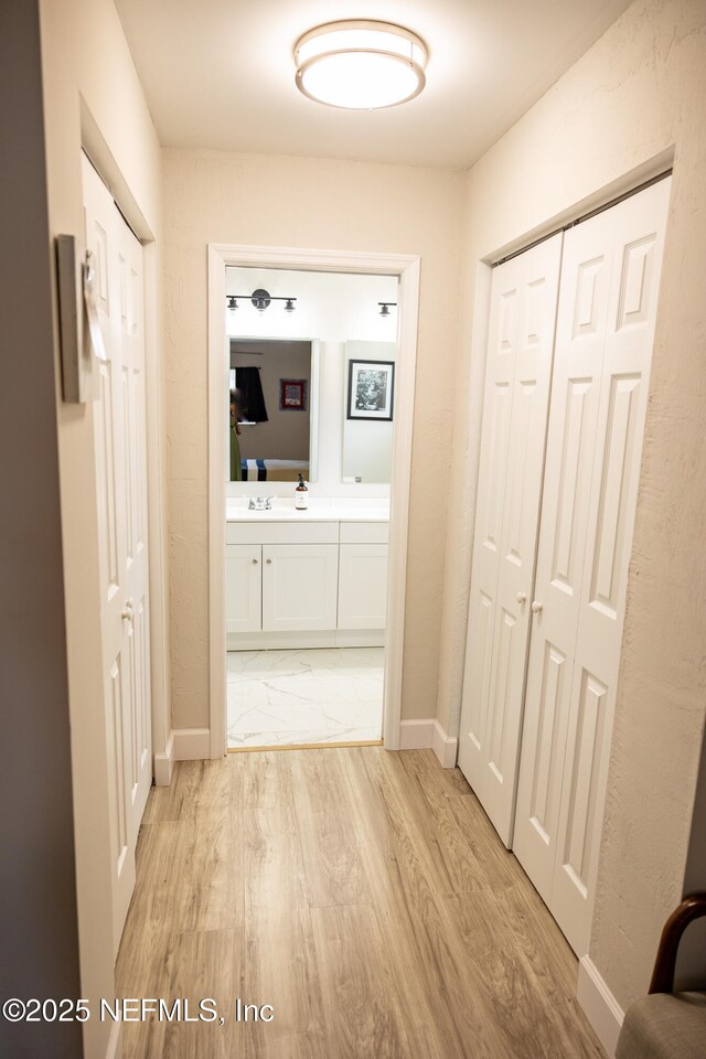 14 Ballard Ln, Palm Coast, FL 32137 - hallway featuring baseboards and light wood-style floors
