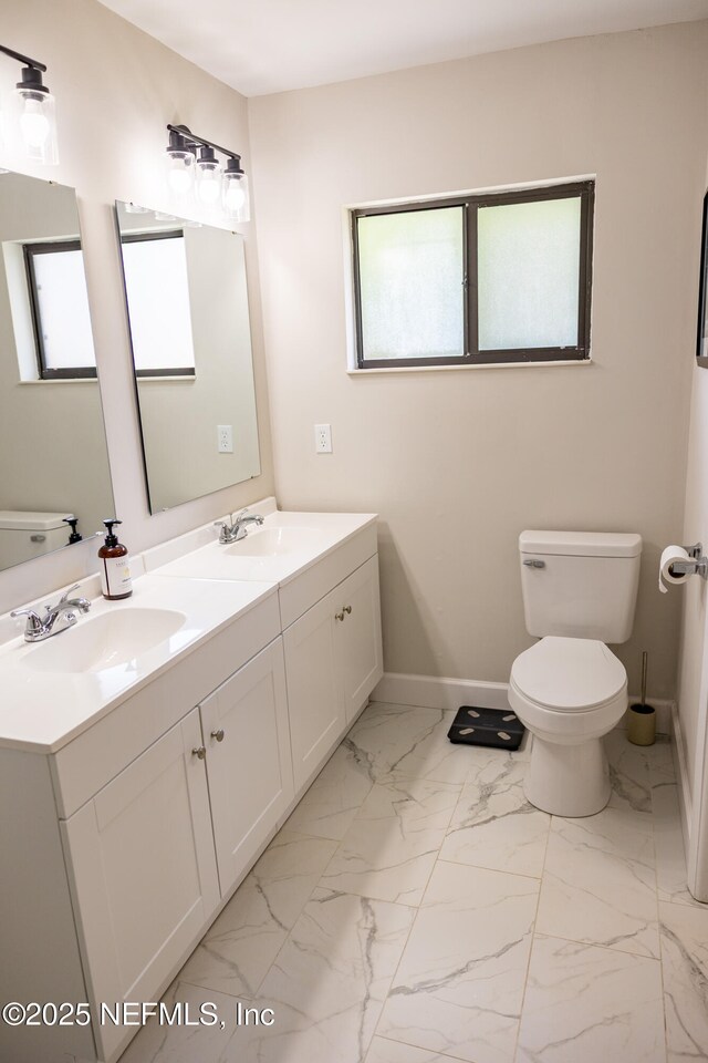 14 Ballard Ln, Palm Coast, FL 32137 - bathroom with double vanity and marble look tile flooring