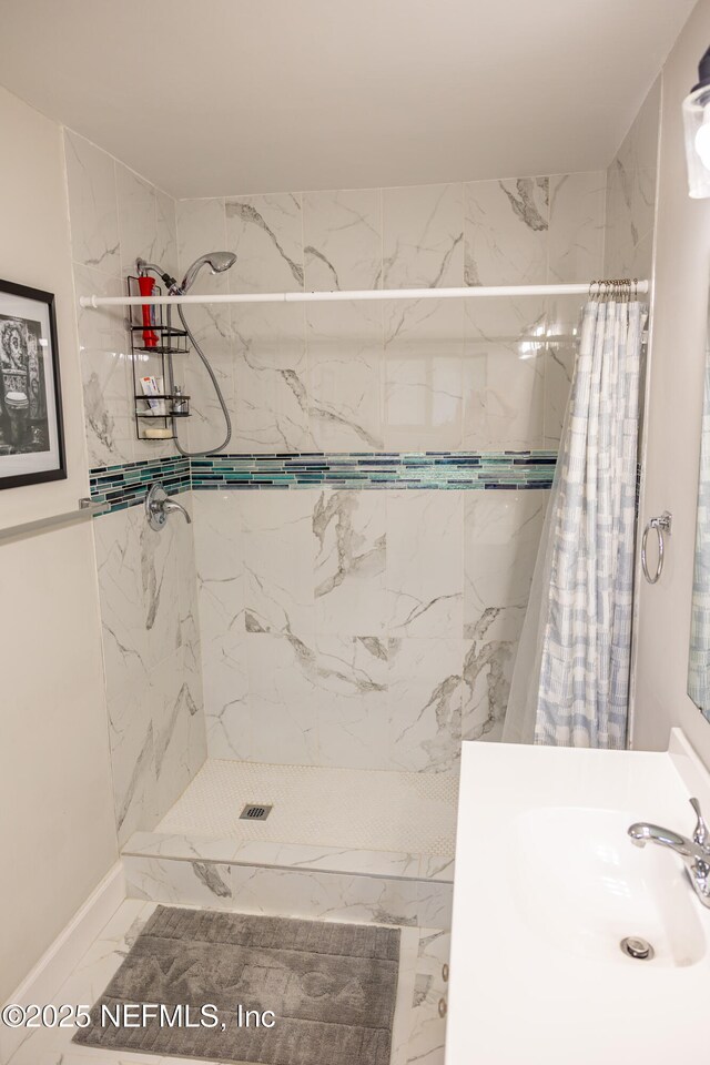 14 Ballard Ln, Palm Coast, FL 32137 - bathroom with marble look tiles, tiled shower, and vanity