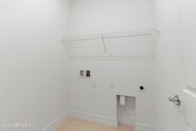 2446 Glade Ln, Green Cove Springs, FL 32043 - washroom featuring electric dryer hookup, hookup for a washing machine, baseboards, and light wood-style flooring