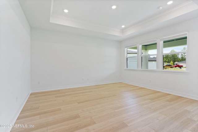 2446 Glade Ln, Green Cove Springs, FL 32043 - empty room with crown molding, a raised ceiling, light wood-style floors, recessed lighting, and baseboards