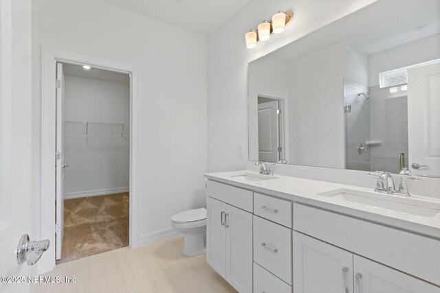 2446 Glade Ln, Green Cove Springs, FL 32043 - full bathroom featuring a shower stall, double vanity, toilet, and a walk in closet