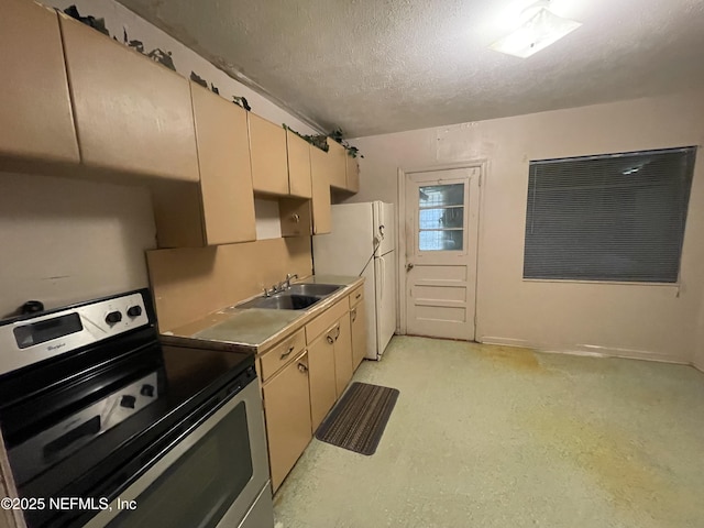 1436 Forest Hills Rd, Jacksonville, FL 32208 - kitchen with electric range, a sink, a textured ceiling, freestanding refrigerator, and cream cabinetry
