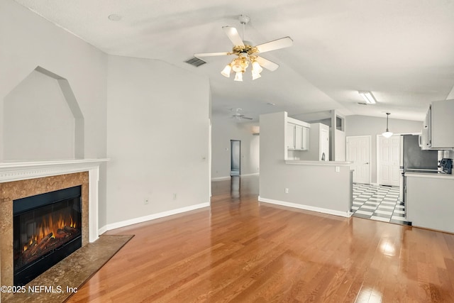 4420 Timber Hollow Way, Jacksonville, FL 32224 - unfurnished living room featuring lofted ceiling, ceiling fan, a fireplace, light wood-type flooring, and baseboards