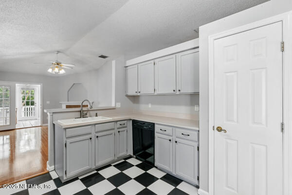 4420 Timber Hollow Way, Jacksonville, FL 32224 - kitchen with dishwasher, a peninsula, a sink, tile patterned floors, and a textured ceiling
