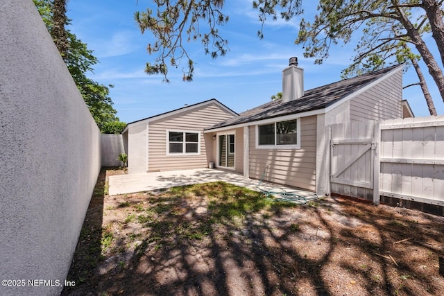 2522 Dauphine Ct W, Ponte Vedra Beach, FL 32082 - back of property featuring a patio area, a chimney, a fenced backyard, and a gate