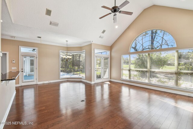 13022 Huntley Manor Dr, Jacksonville, FL 32224 - unfurnished living room featuring ceiling fan, a chandelier, dark wood-type flooring, baseboards, and high vaulted ceiling
