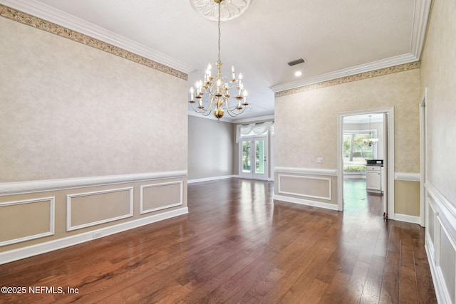 13022 Huntley Manor Dr, Jacksonville, FL 32224 - unfurnished room with ornamental molding, a chandelier, dark wood finished floors, a decorative wall, and a wainscoted wall