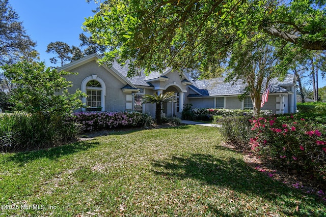 13022 Huntley Manor Dr, Jacksonville, FL 32224 - view of front of home with a front lawn and stucco siding