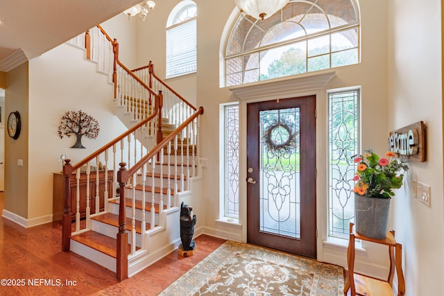 6449 Jack Wright Island Rd, Saint Augustine, FL 32092 - entrance foyer with wood finished floors, plenty of natural light, a towering ceiling, baseboards, and stairs