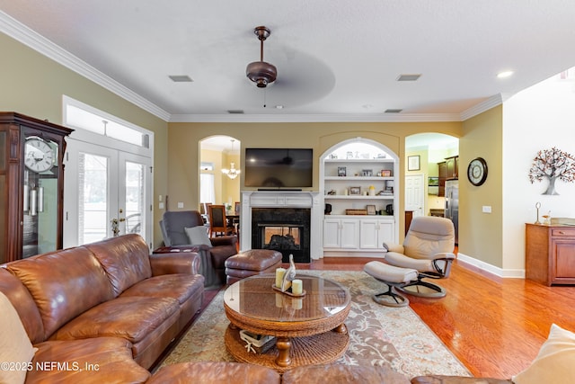 6449 Jack Wright Island Rd, Saint Augustine, FL 32092 - living room featuring arched walkways, light wood-type flooring, ornamental molding, ceiling fan, and built in features