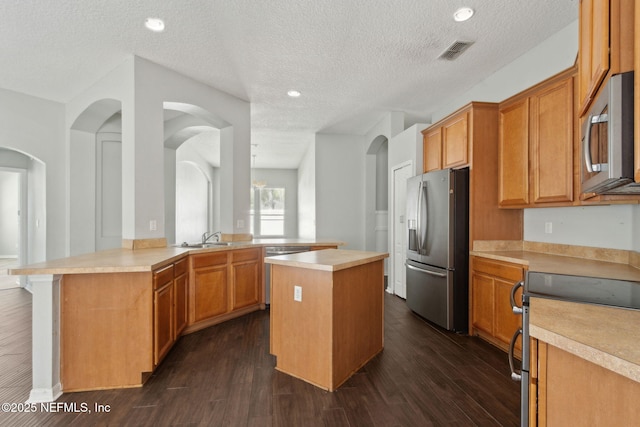 3353 Horseshoe Trail Dr, Orange Park, FL 32065 - kitchen with appliances with stainless steel finishes, a peninsula, light countertops, a textured ceiling, and recessed lighting