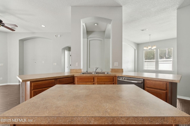 3353 Horseshoe Trail Dr, Orange Park, FL 32065 - kitchen with a sink, arched walkways, dishwasher, a peninsula, and a textured ceiling