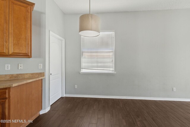 3353 Horseshoe Trail Dr, Orange Park, FL 32065 - unfurnished dining area featuring dark wood-style flooring and baseboards