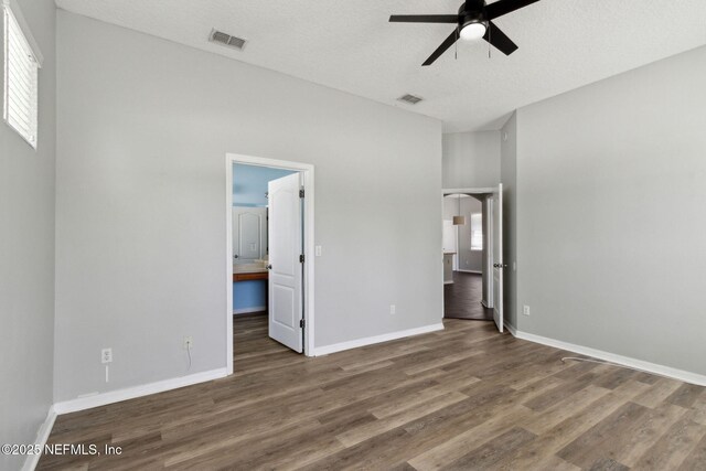 3353 Horseshoe Trail Dr, Orange Park, FL 32065 - unfurnished bedroom with wood finished floors, baseboards, a ceiling fan, and a textured ceiling