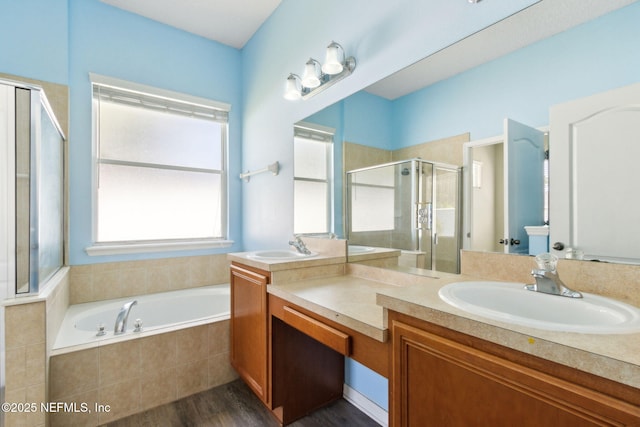 3353 Horseshoe Trail Dr, Orange Park, FL 32065 - full bathroom featuring vanity, a stall shower, a garden tub, and wood finished floors