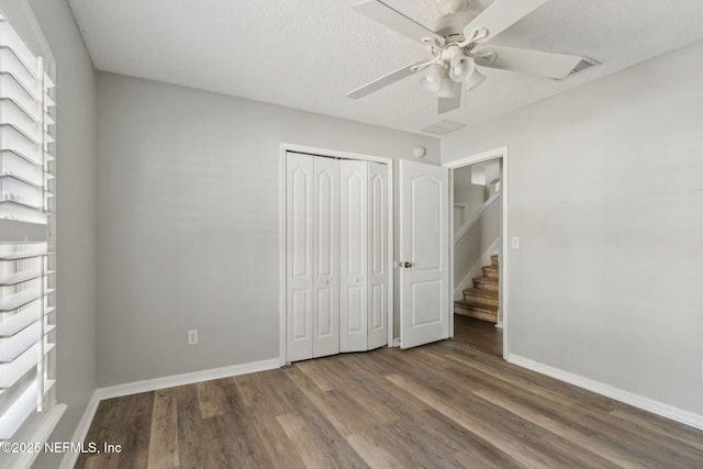 3353 Horseshoe Trail Dr, Orange Park, FL 32065 - unfurnished bedroom with wood finished floors, a closet, baseboards, a ceiling fan, and multiple windows