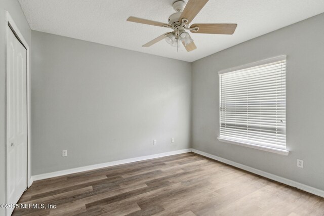 3353 Horseshoe Trail Dr, Orange Park, FL 32065 - unfurnished bedroom with wood finished floors, a closet, baseboards, and ceiling fan