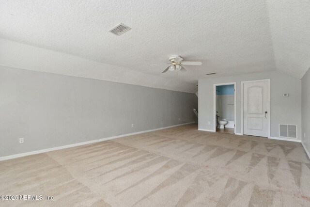 3353 Horseshoe Trail Dr, Orange Park, FL 32065 - additional living space with vaulted ceiling, ceiling fan, light carpet, baseboards, and a textured ceiling