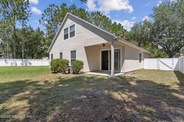 3353 Horseshoe Trail Dr, Orange Park, FL 32065 - back of property featuring a ceiling fan, a gate, stucco siding, and a patio area