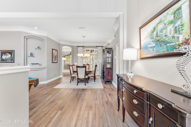 1758 Country Walk Dr, Fleming Island, FL 32003 - dining space with a chandelier, light wood-type flooring, ornamental molding, arched walkways, and recessed lighting
