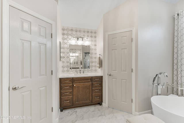 1758 Country Walk Dr, Fleming Island, FL 32003 - bathroom featuring vanity, a soaking tub, marble look tiles, and vaulted ceiling