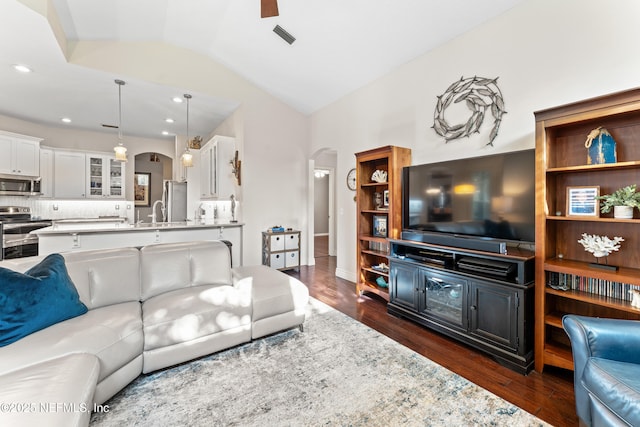 1758 Country Walk Dr, Fleming Island, FL 32003 - living area with arched walkways, vaulted ceiling, dark wood-style floors, recessed lighting, and a ceiling fan