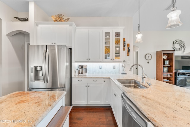 1758 Country Walk Dr, Fleming Island, FL 32003 - kitchen featuring appliances with stainless steel finishes, dark wood finished floors, light stone counters, glass insert cabinets, and white cabinetry