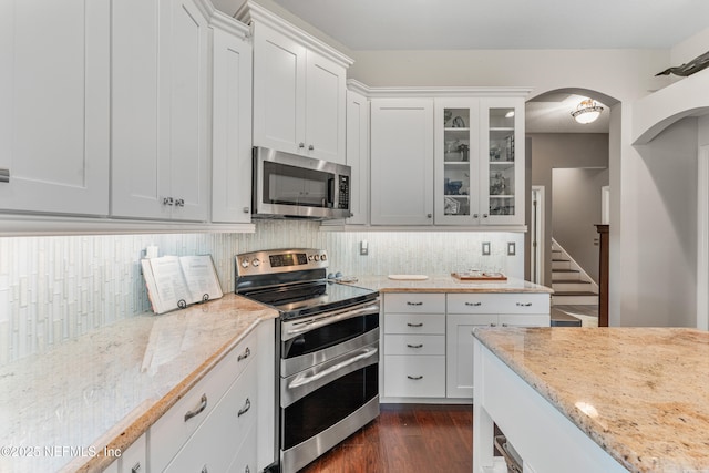 1758 Country Walk Dr, Fleming Island, FL 32003 - kitchen featuring stainless steel appliances, decorative backsplash, glass insert cabinets, and light stone counters