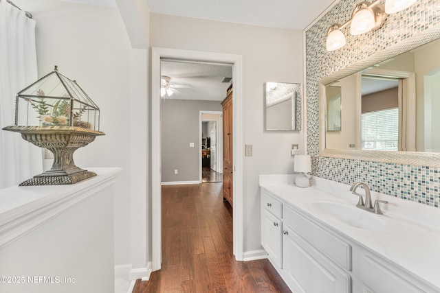 1758 Country Walk Dr, Fleming Island, FL 32003 - bathroom featuring wood finished floors, vanity, backsplash, and a ceiling fan