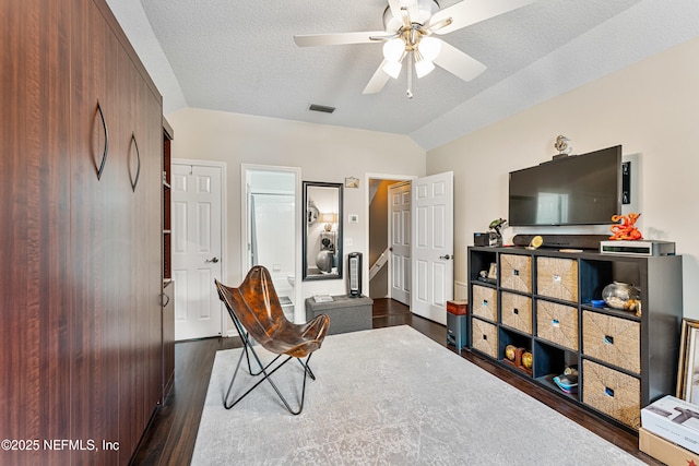 1758 Country Walk Dr, Fleming Island, FL 32003 - living area featuring dark wood-style floors, a ceiling fan, lofted ceiling, and a textured ceiling